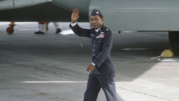 Former POW and U.S. Air Force COL Fred Vann Cherry (Captured 22 Oct 65) waves to the public and press there to greet the plane load of former POWs flown in from Clark Air Base. COL Cherry was released by the North Vietnamese in Hanoi on12 Feb 73.