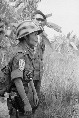 19 Jun 1965 --- serves as a combat master sergeant under the command of her husband, Major Le Van Dan (rear, with glasses), in the crack 44th South Vietnamese Ranger Battalion. The unit has never lost a battle or a gun- to the Red Viet Cong Guerrillas. The major and his fighting wife have seven children. --- Image by © Bettmann/CORBIS