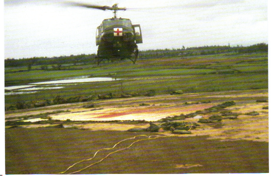 A Dust Off helicopter landing with a load of wounded at the LZ Hawk Hill aid station pad in early 1970. (Photo by the author.)