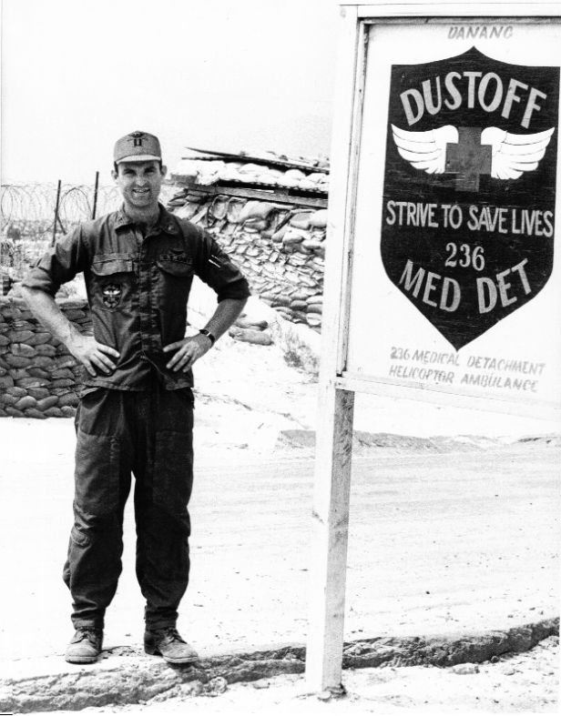 The author standing beside a facsimile of their unit patch outside their orderly room on 7 Mar 70, after being promoted to unit commander at Red Beach in Da Nang. (Photo courtesy of the author.)